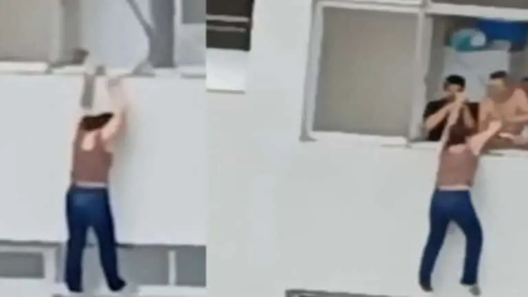 Mulher escorrega limpando janela