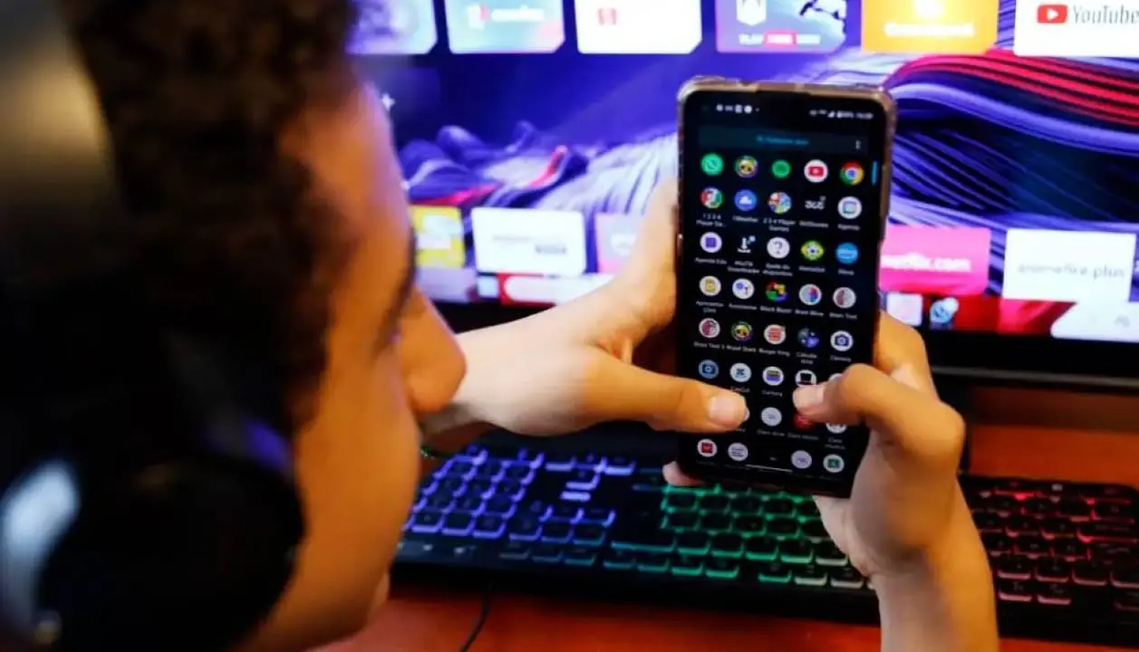 jovem mexendo em celular