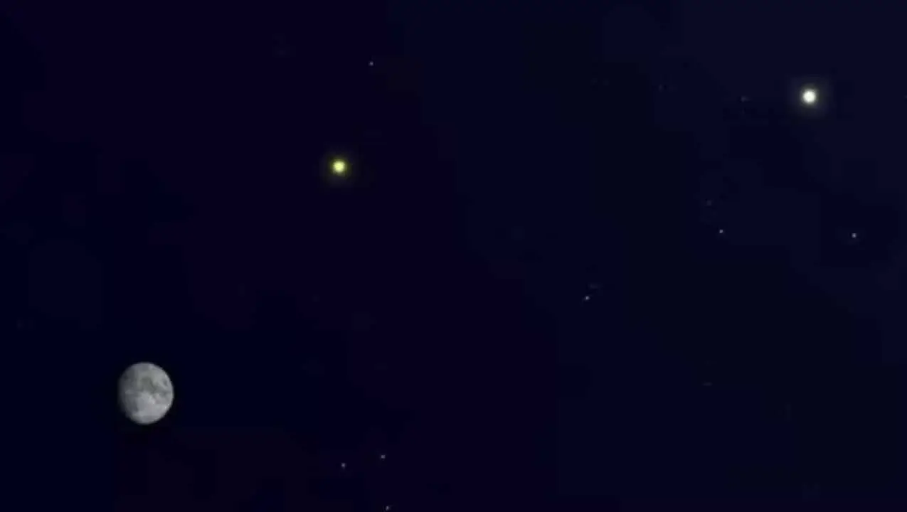 Saturno aparece ao lado da Lua iluminada
