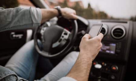 homem dirigindo enquanto está no celular
