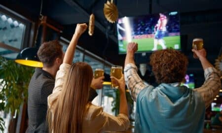 Pessoas no bar assistindo jogo de futebol