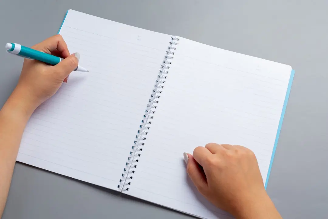 Person writing, left-handed